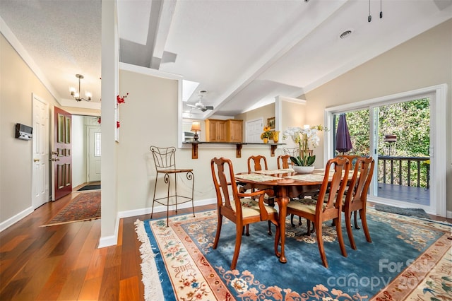 dining area featuring dark wood-type flooring, vaulted ceiling with beams, and ceiling fan with notable chandelier