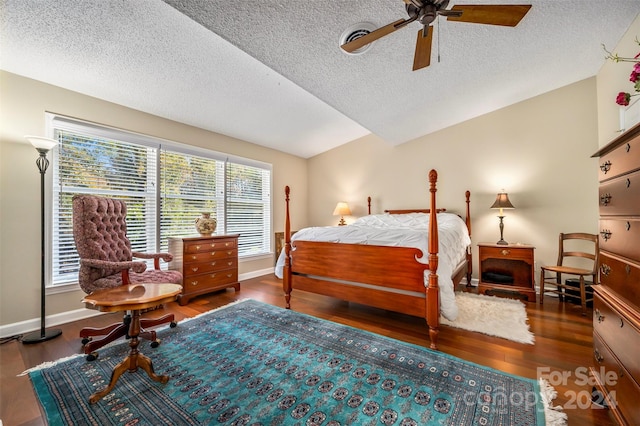 bedroom featuring a textured ceiling, vaulted ceiling, dark hardwood / wood-style floors, and ceiling fan