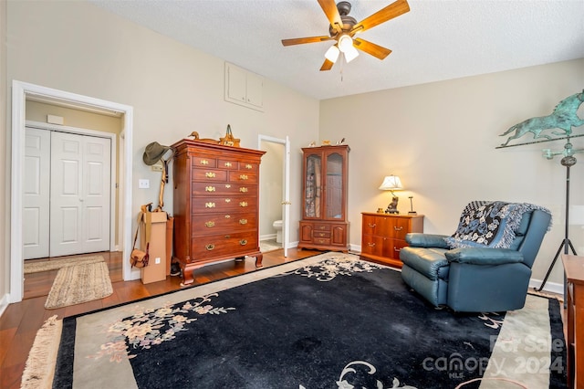 sitting room with a textured ceiling, hardwood / wood-style flooring, and ceiling fan