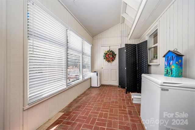 laundry area with wood walls