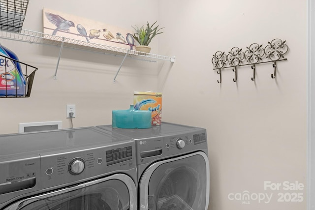 clothes washing area with washer and clothes dryer