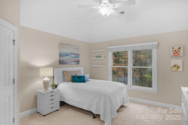 bedroom featuring ceiling fan, light carpet, and multiple windows