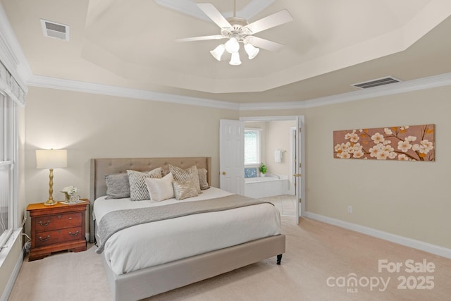 bedroom with light carpet, a tray ceiling, ceiling fan, and ornamental molding