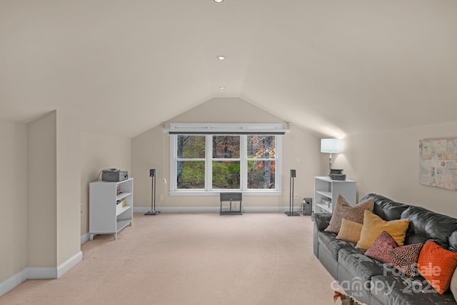 interior space with light colored carpet and vaulted ceiling