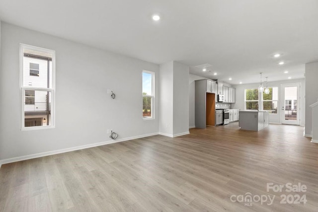 unfurnished living room featuring light wood-type flooring