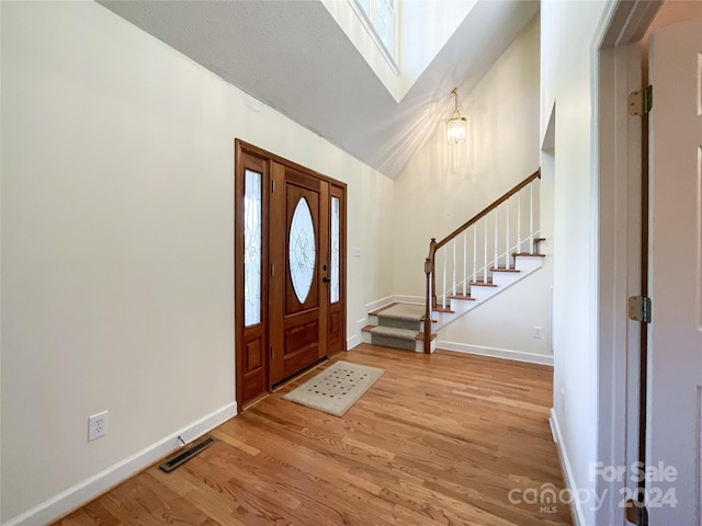 foyer with a skylight and light wood-type flooring