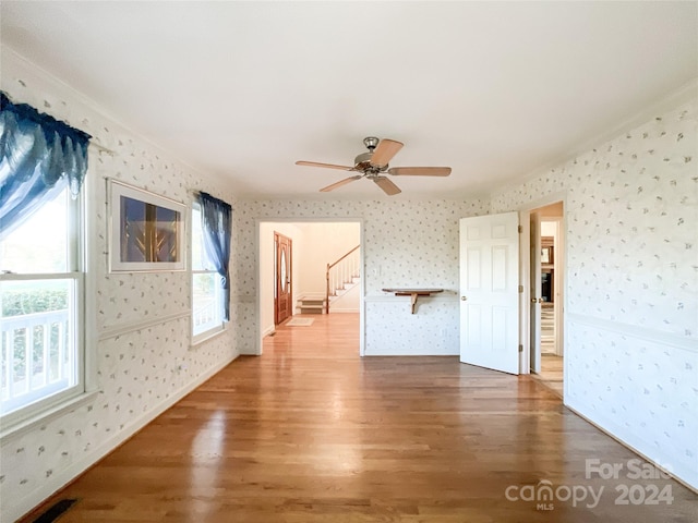 spare room featuring ceiling fan, ornamental molding, and hardwood / wood-style floors