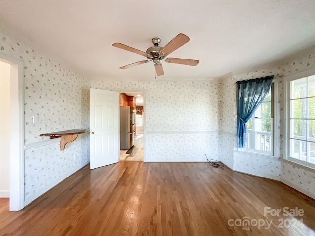 unfurnished living room with ceiling fan and hardwood / wood-style flooring