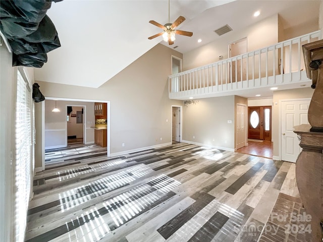 interior space featuring ceiling fan, high vaulted ceiling, and hardwood / wood-style floors