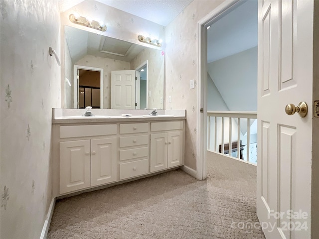 bathroom featuring vanity and lofted ceiling