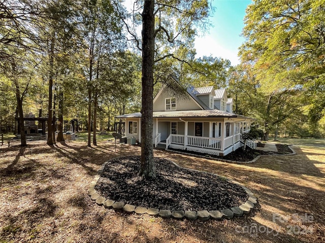 back of house featuring covered porch