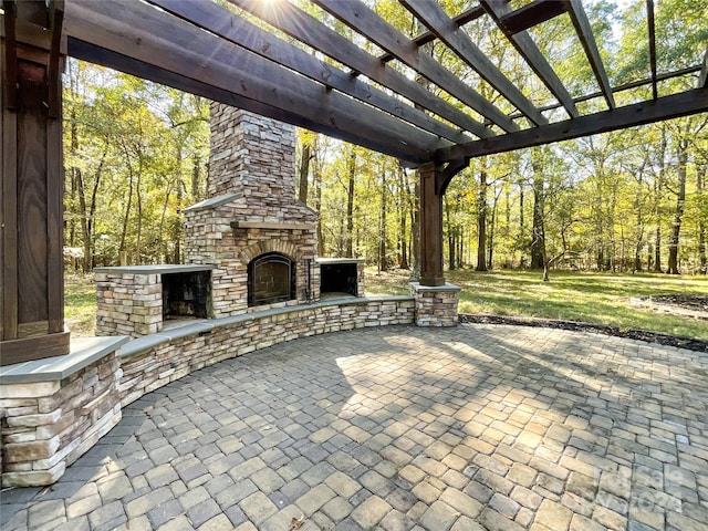 view of patio / terrace with an outdoor stone fireplace and a pergola