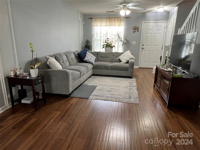 living room with ceiling fan and dark hardwood / wood-style floors