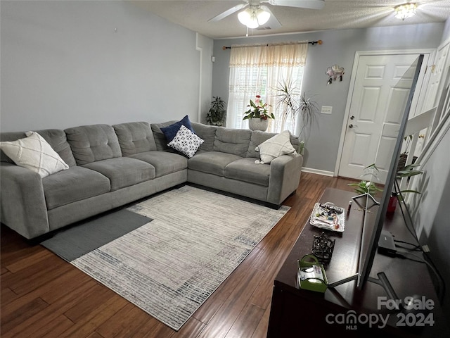 living room featuring dark hardwood / wood-style floors and ceiling fan