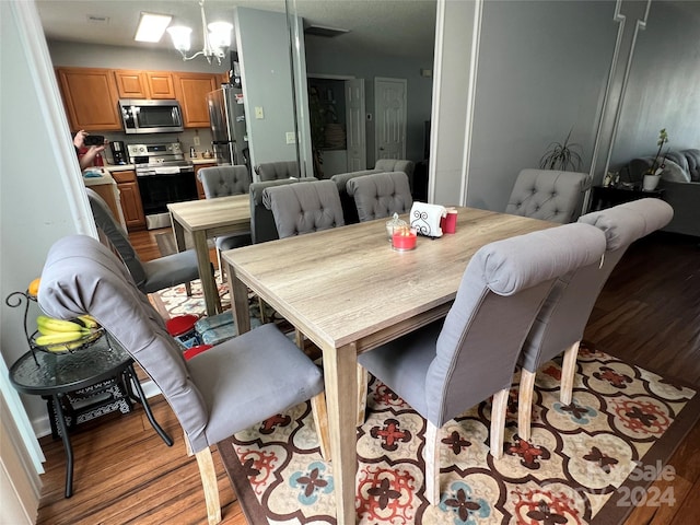 dining room featuring a chandelier and light wood-type flooring