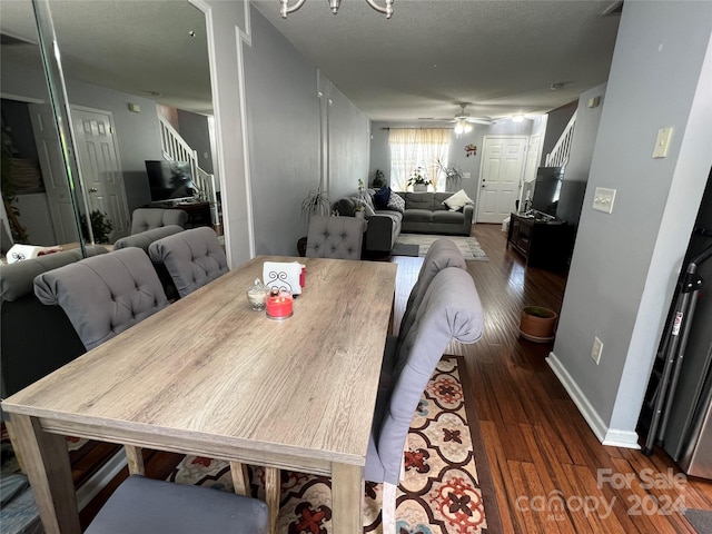 dining room with dark wood-type flooring, ceiling fan, and a textured ceiling