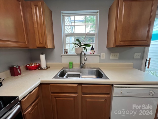 kitchen featuring white dishwasher and sink