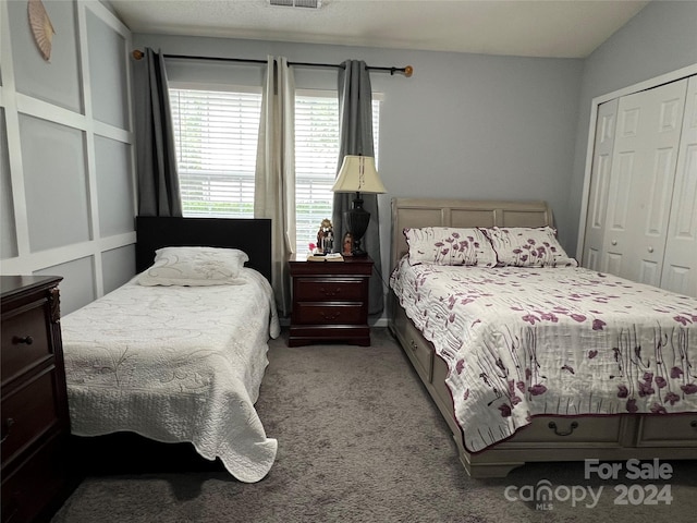 bedroom with light carpet and a closet