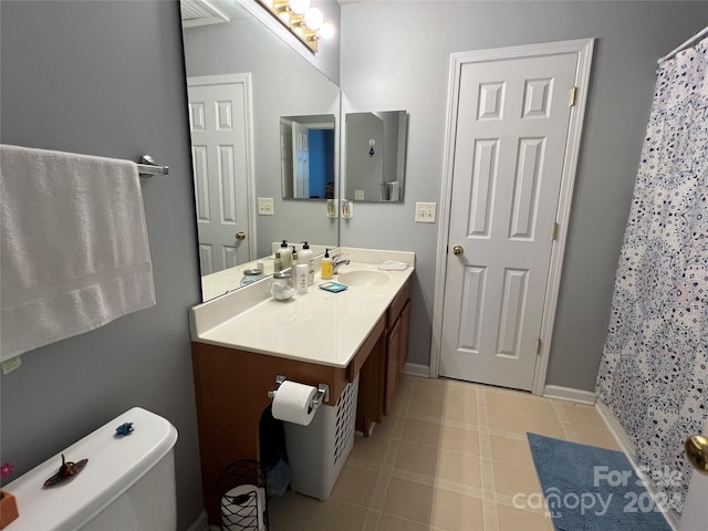 bathroom featuring vanity, toilet, and curtained shower