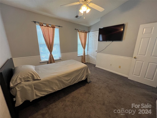 carpeted bedroom with vaulted ceiling and ceiling fan