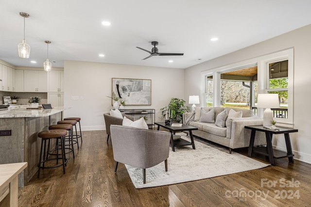 living room featuring dark hardwood / wood-style flooring and ceiling fan