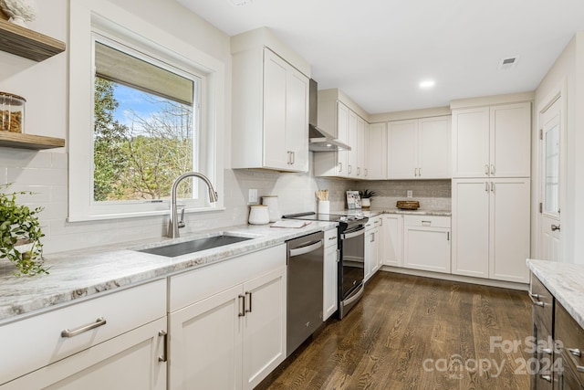 kitchen with sink, dark wood-type flooring, decorative backsplash, white cabinets, and appliances with stainless steel finishes