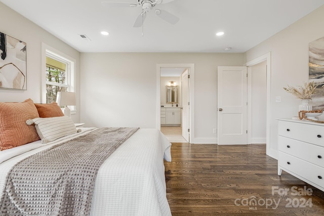 bedroom with ensuite bathroom, ceiling fan, and dark wood-type flooring