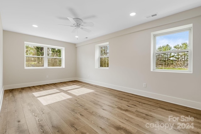 unfurnished room with ceiling fan and light wood-type flooring