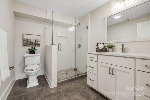 bathroom featuring vanity, an enclosed shower, and toilet