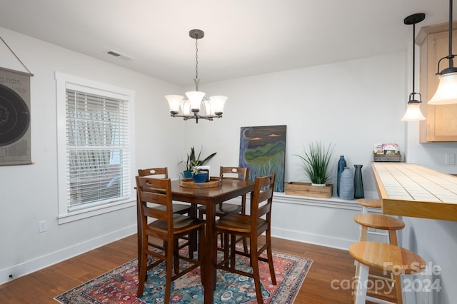 dining room featuring dark wood-type flooring and a chandelier