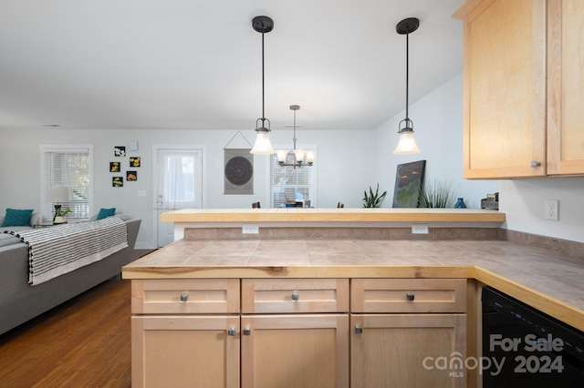 kitchen with light brown cabinets, hardwood / wood-style floors, black dishwasher, a notable chandelier, and decorative light fixtures