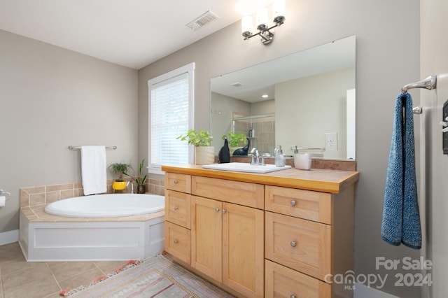 bathroom featuring vanity, independent shower and bath, and tile patterned flooring