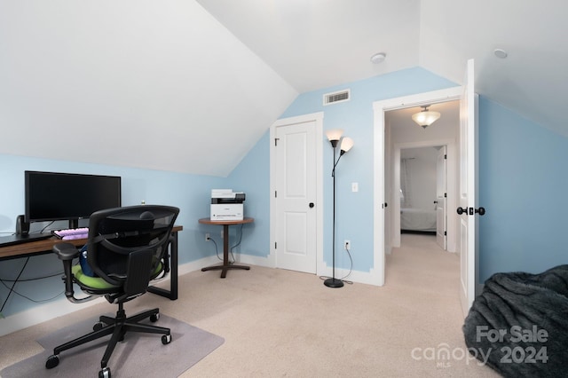 office space with vaulted ceiling and light colored carpet