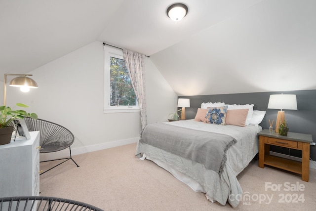 carpeted bedroom with lofted ceiling