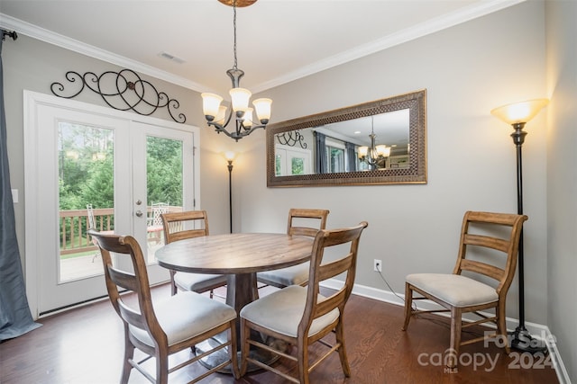 dining room with ornamental molding, french doors, dark wood-type flooring, and an inviting chandelier