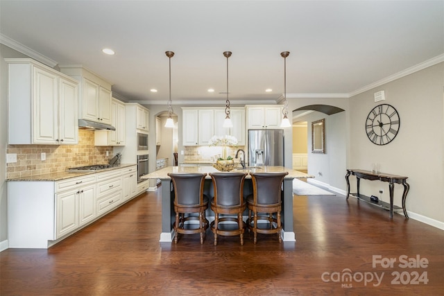 kitchen featuring dark wood-type flooring, pendant lighting, light stone countertops, and stainless steel appliances