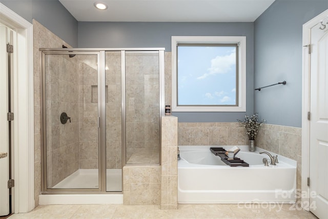 bathroom featuring shower with separate bathtub and tile patterned floors