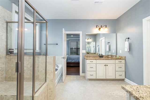 bathroom featuring vanity, tile patterned floors, and separate shower and tub