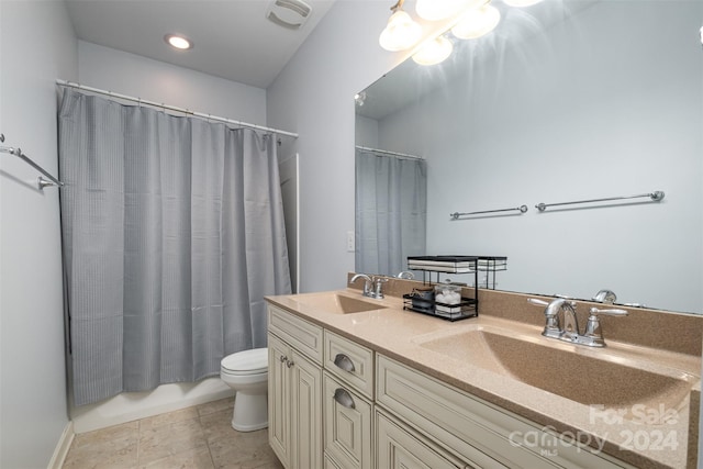 full bathroom featuring tile patterned flooring, vanity, toilet, and shower / tub combo