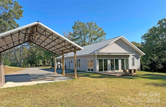 rear view of house with a wooden deck and a yard