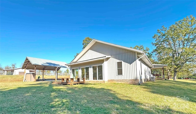 back of property with a shed, a wooden deck, and a lawn