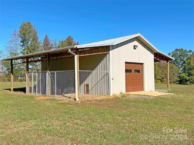 view of outdoor structure with a lawn and a garage