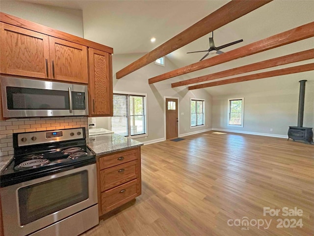 kitchen featuring light hardwood / wood-style flooring, a healthy amount of sunlight, stainless steel appliances, and stone counters