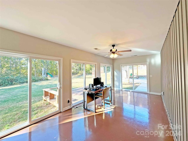 office space featuring concrete flooring and ceiling fan