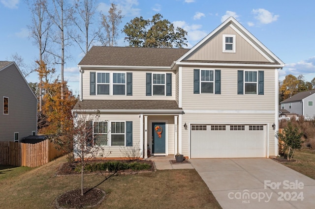 view of front property featuring a front lawn and a garage