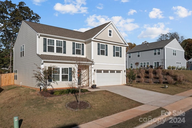 view of front property with a front yard and a garage