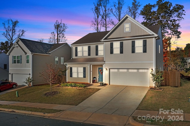 view of front of home featuring a yard and a garage