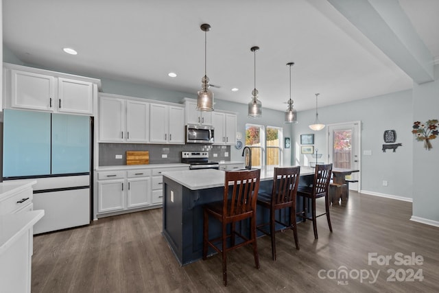 kitchen featuring hanging light fixtures, dark hardwood / wood-style flooring, an island with sink, white cabinetry, and stainless steel appliances