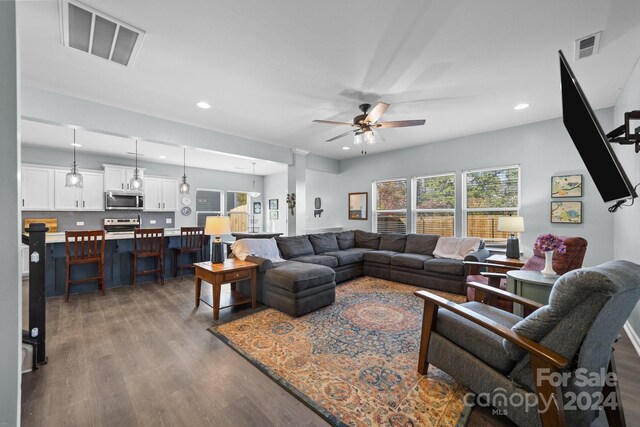 living room with hardwood / wood-style floors and ceiling fan