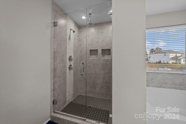 bathroom with shower with separate bathtub